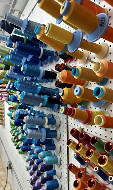 Industrial embroidery thread wall, hundreds of colors in stock.